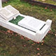New white marble tablet added at foot of grave